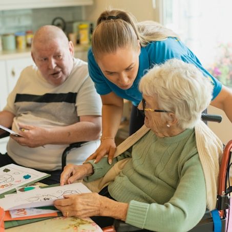 Two seniors enjoying an activity together at a table